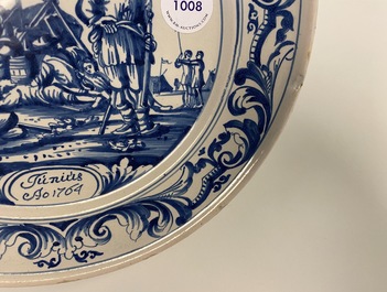 A Dutch Delftware blue and white dish with soldiers at camp, Makkum, dated 1764